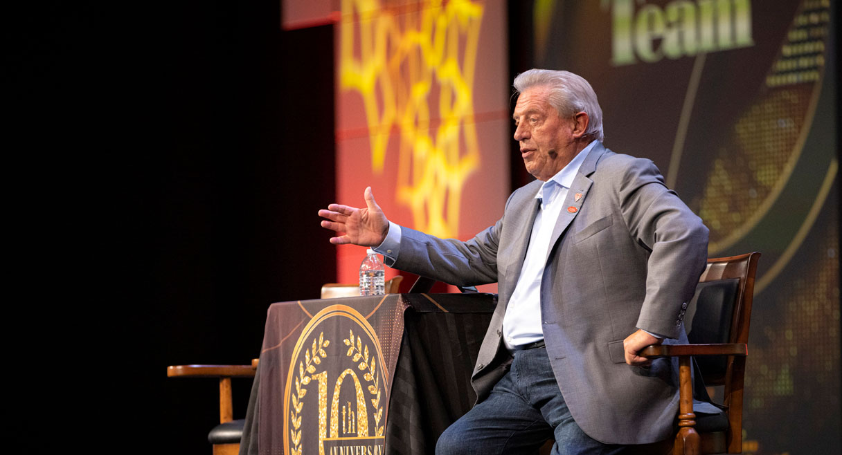Photo of John Maxwell speaking from the stage at an event.